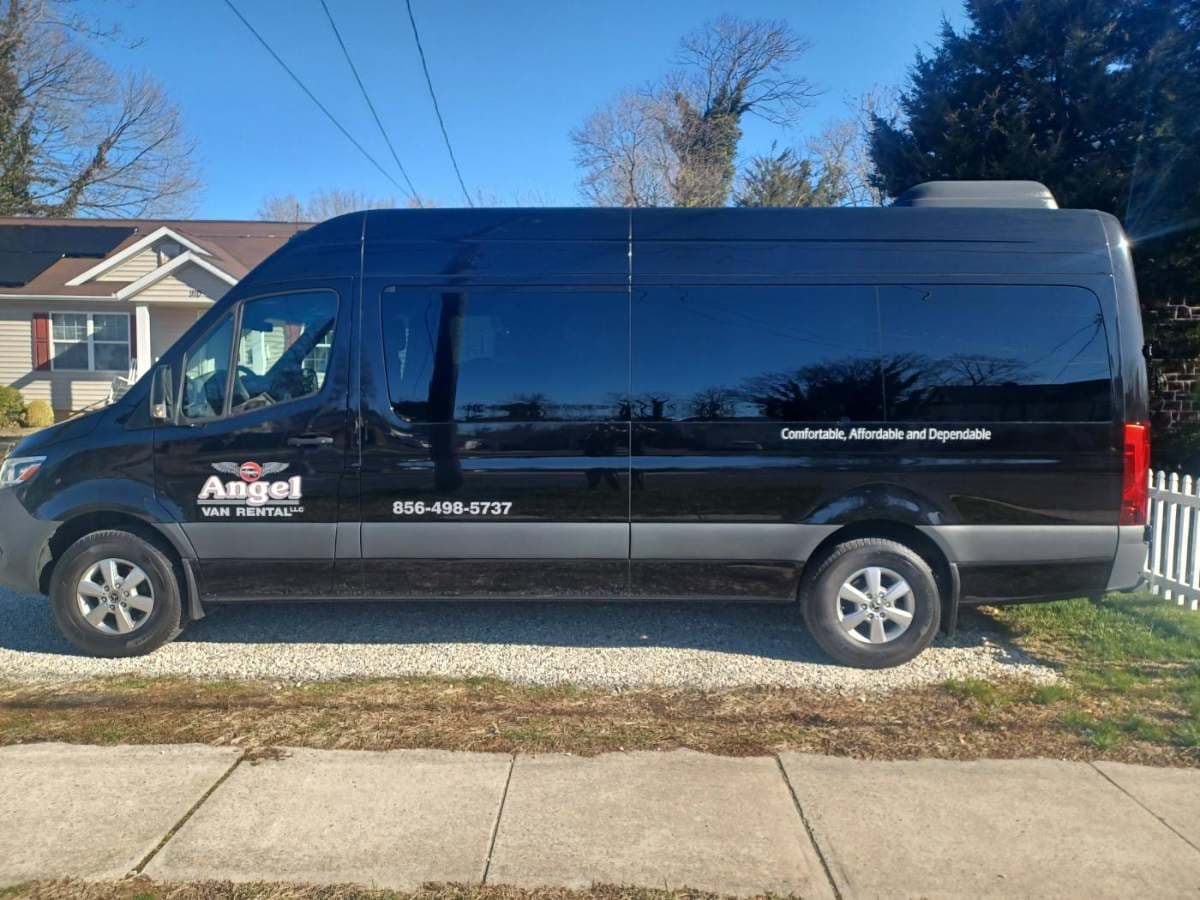 Black 2023 Mercedes Sprinter 15-passenger van, side view